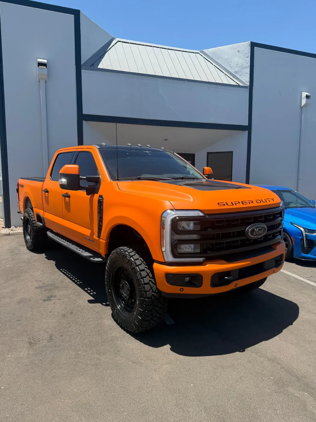 Orange lifted Ford F-250 Super Duty detailed by a mobile detailing team in Phoenix, Arizona