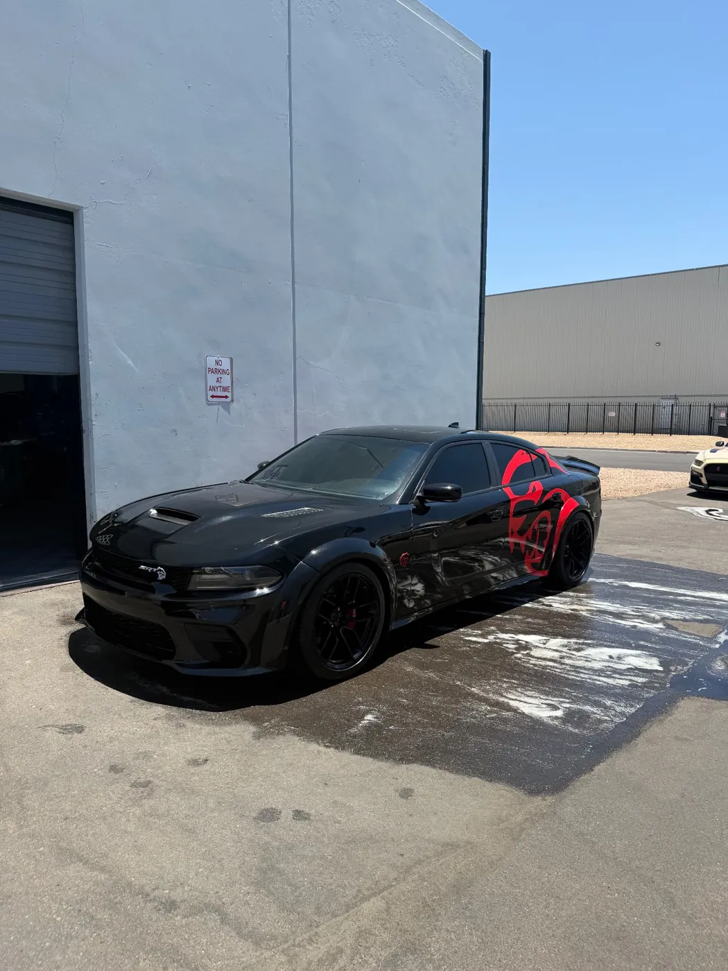 Black Dodge Charger Hellcat Widebody with swirl-free black paint after a mobile detail in Arizona