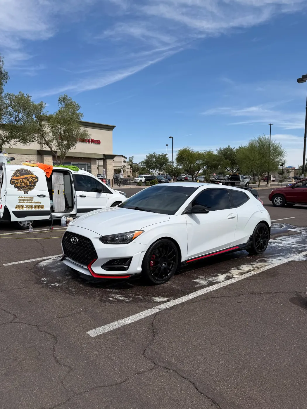White Hyundai Veloster N being detailed next to the Carson's Mobile Detailing van in a Phoenix parking lot