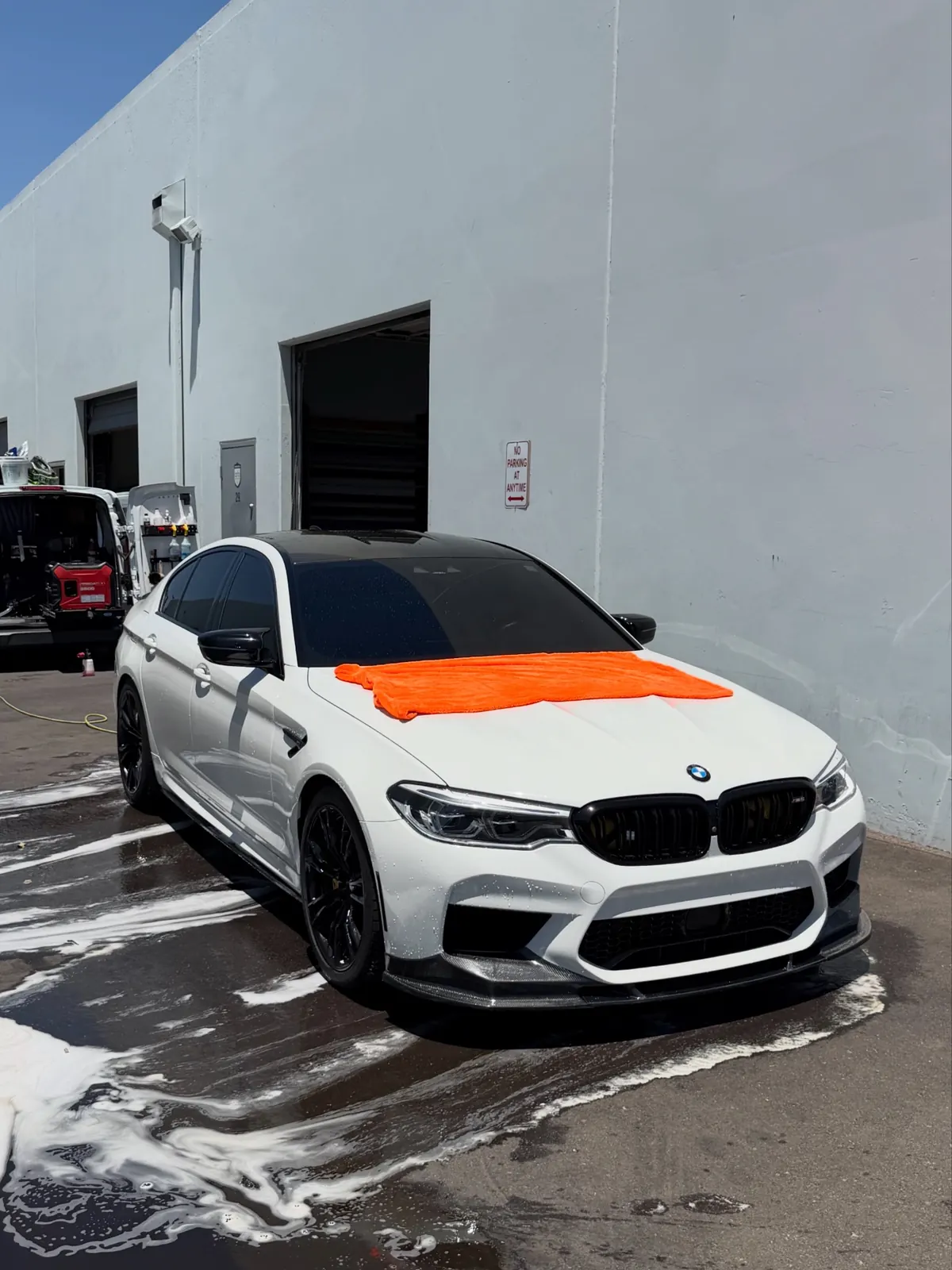 BMW M5 with a glossy ceramic-coated paint finish reflecting Arizona sunlight after professional paint correction
