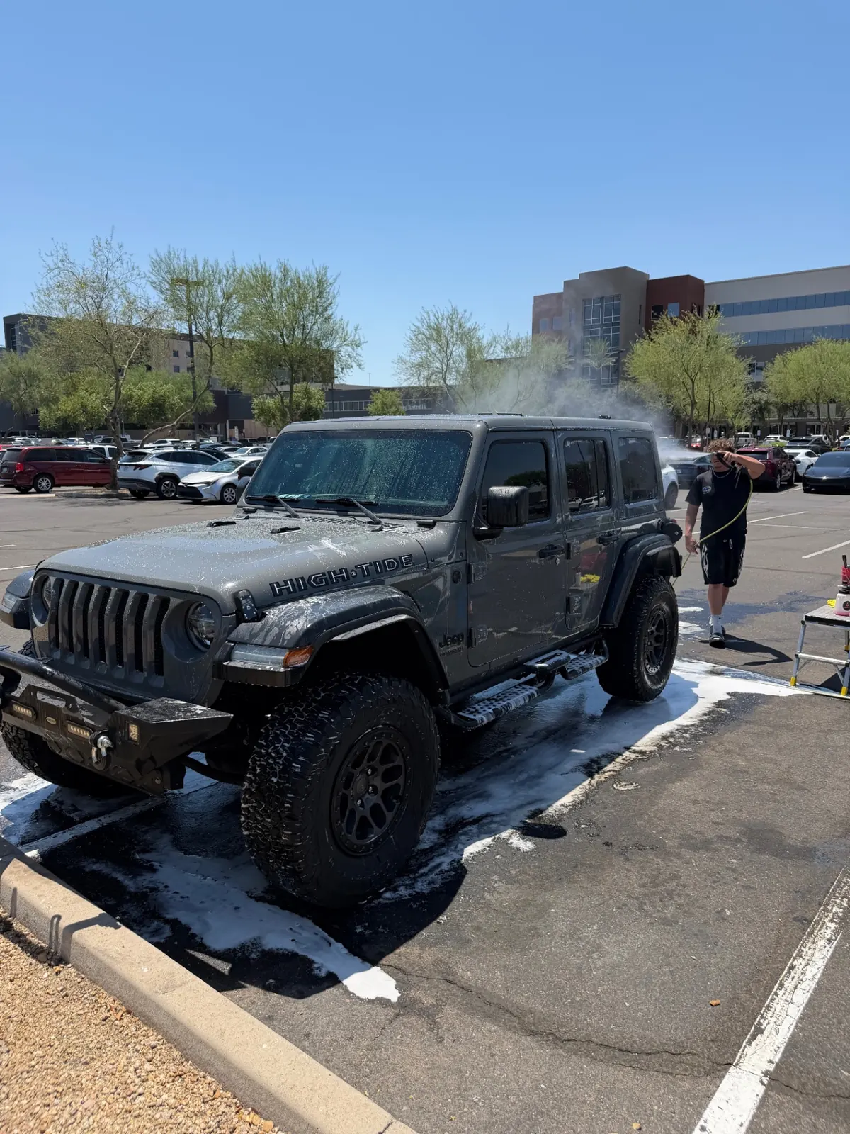 Carson detailing a black Jeep Wrangler interior with deep vacuuming and leather conditioning in Surprise, Arizona